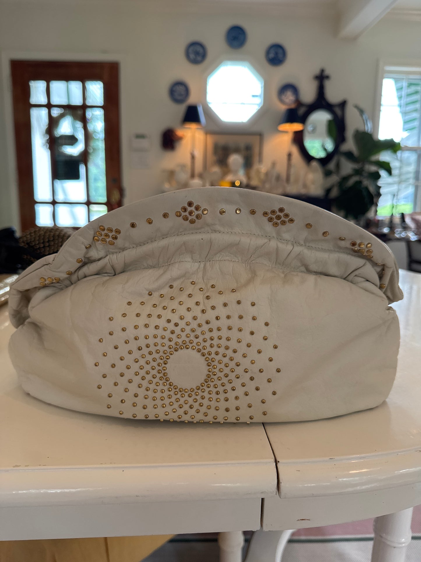Cream, leather, structured clutch with gold grommets