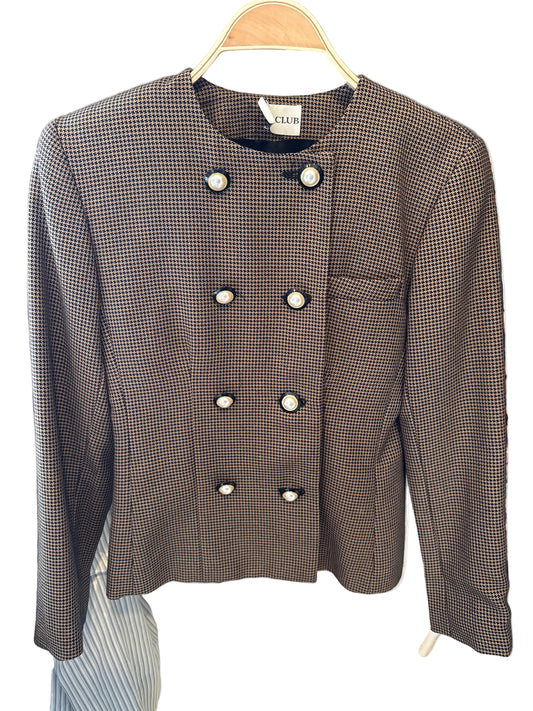 Brown checkered blazer with white buttons on a hanger