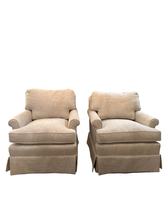 Pair of beige linen, newly upholstered vintage club chairs. Detached seat, cushion, and back cushion, rolled arm.