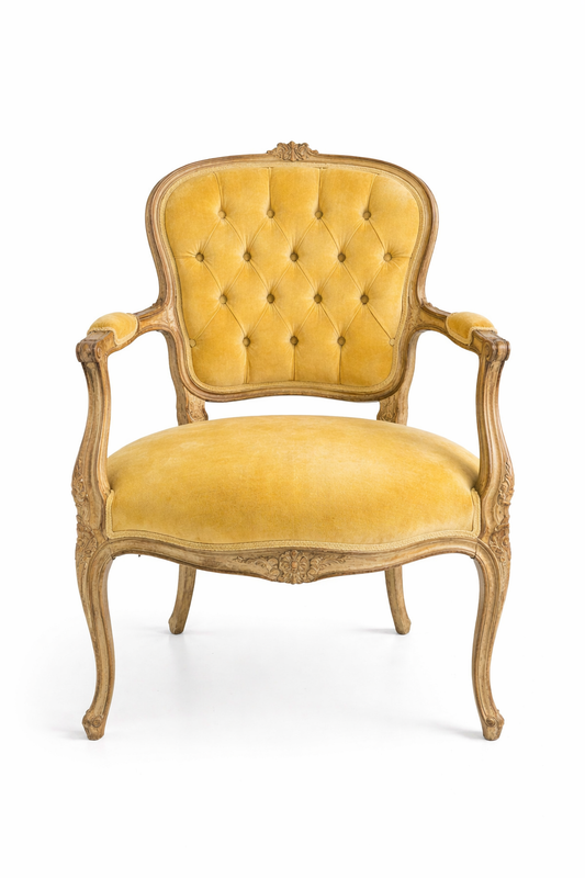 Vintage yellow armchair with ornate wooden frame on a white background