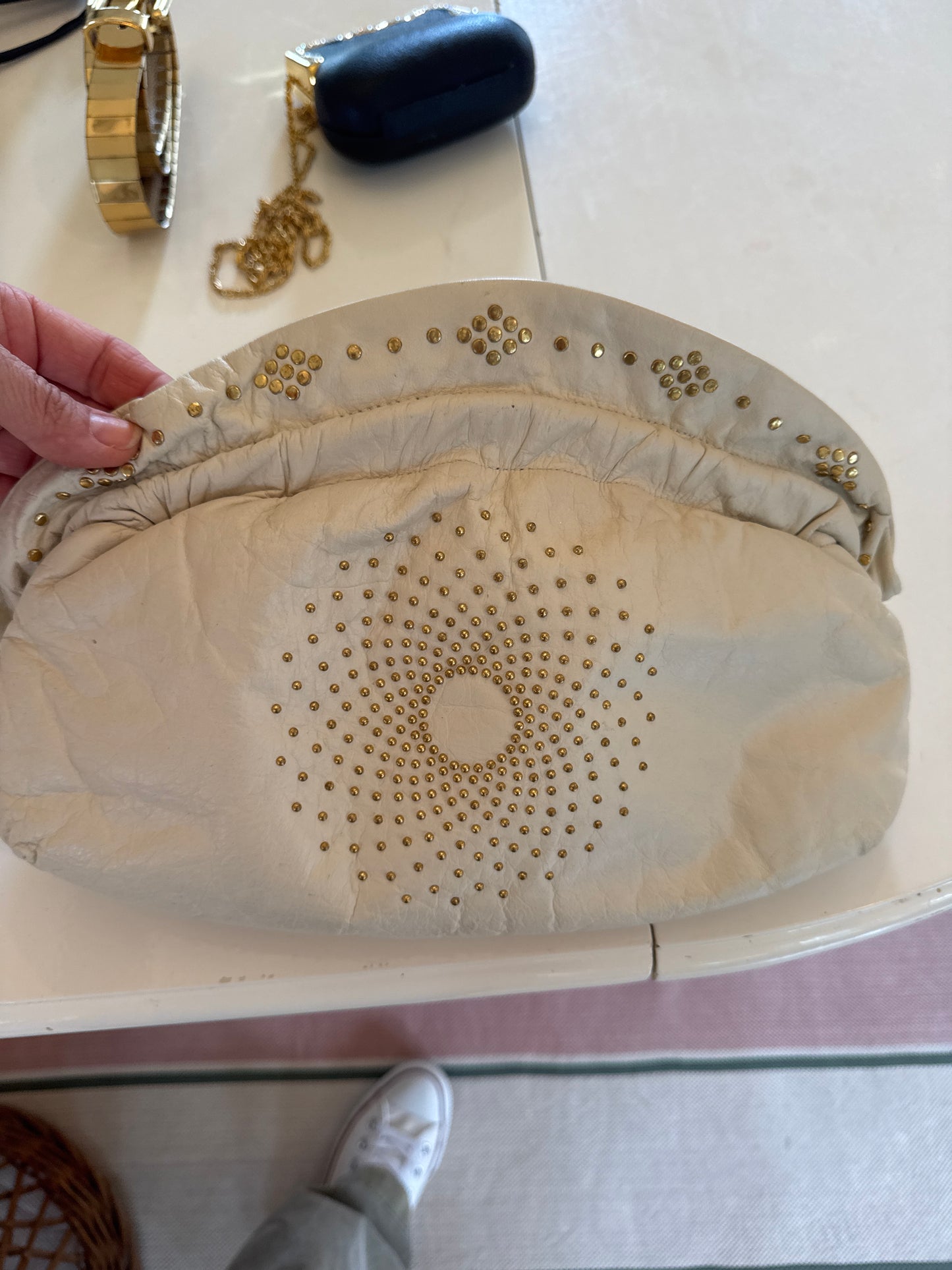 Cream, leather, structured clutch with gold grommets
