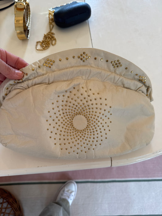 Cream, leather, structured clutch with gold grommets